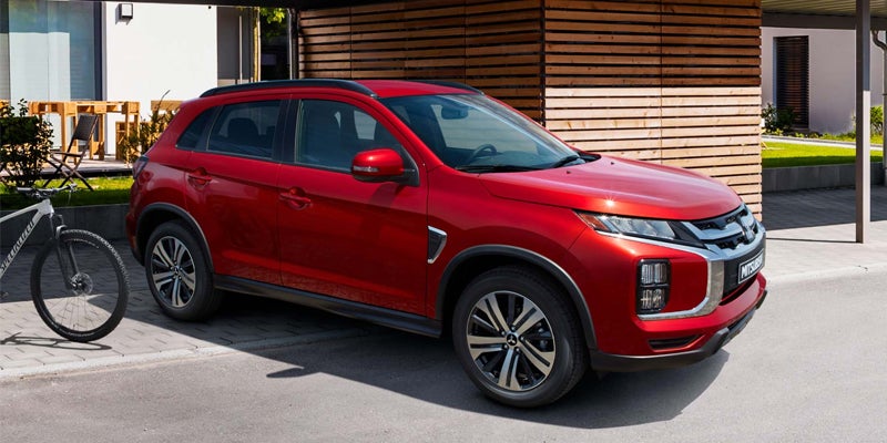 Right side view of a red 2023 Mitsubishi Outlander Sport